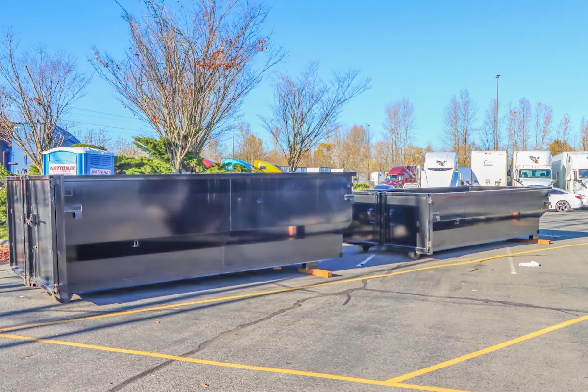 Professional dumpster rental service with roll-off container on residential driveway in Frankenmuth